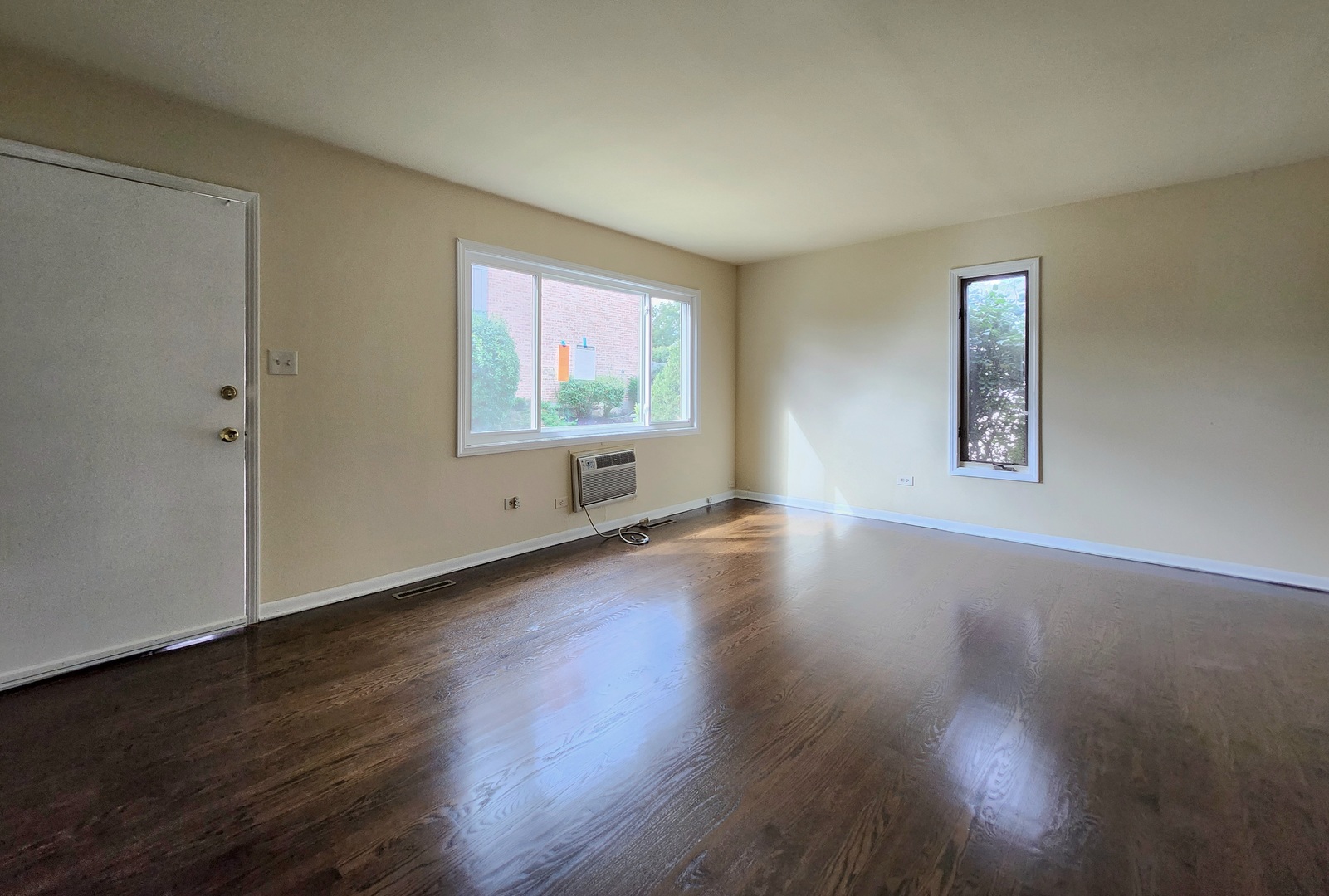 818 Concord Lane, Unit 818 Barrington, IL 60010 - Photo 9 of 16 a view of an empty room with wooden floor and a window