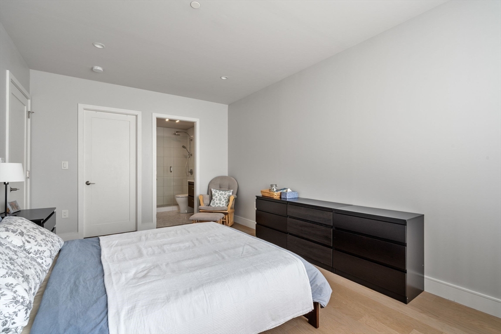44-50 Symphony Road, Unit 403 Boston, MA 02115 - Photo 15 of 28 a bedroom with a bed and a dresser