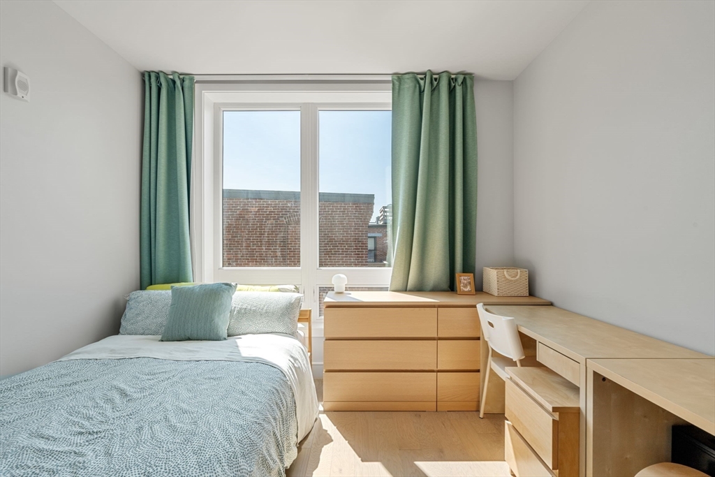 44-50 Symphony Road, Unit 403 Boston, MA 02115 - Photo 17 of 28 a bedroom with a bed and a window