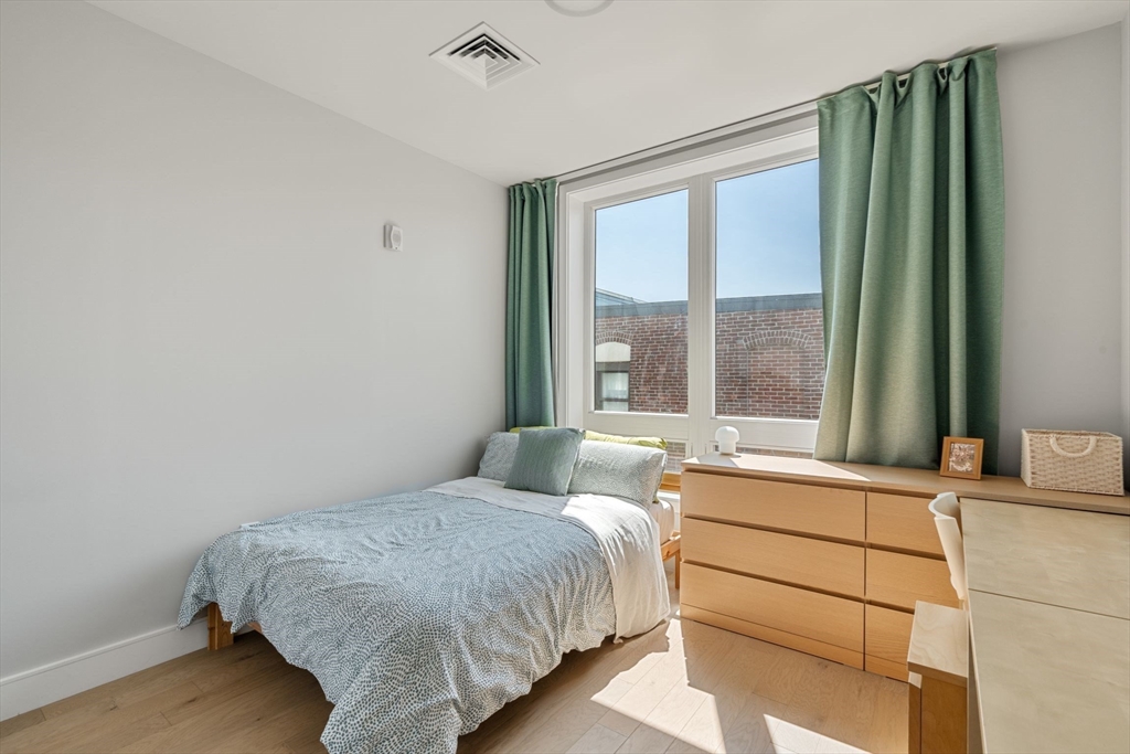 44-50 Symphony Road, Unit 403 Boston, MA 02115 - Photo 18 of 28 a bedroom with a bed and a large window