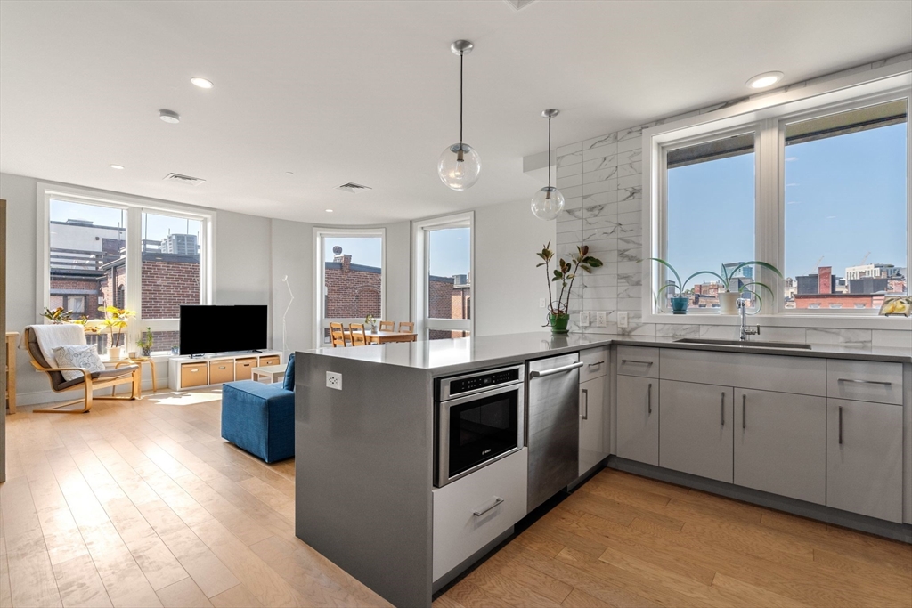 44-50 Symphony Road, Unit 403 Boston, MA 02115 - Photo 4 of 28 a kitchen with stainless steel appliances granite countertop a stove and a sink