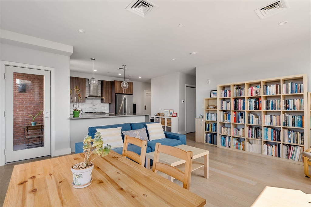 44-50 Symphony Road, Unit 403 Boston, MA 02115 - Photo 7 of 28 a living room with furniture and a book shelf