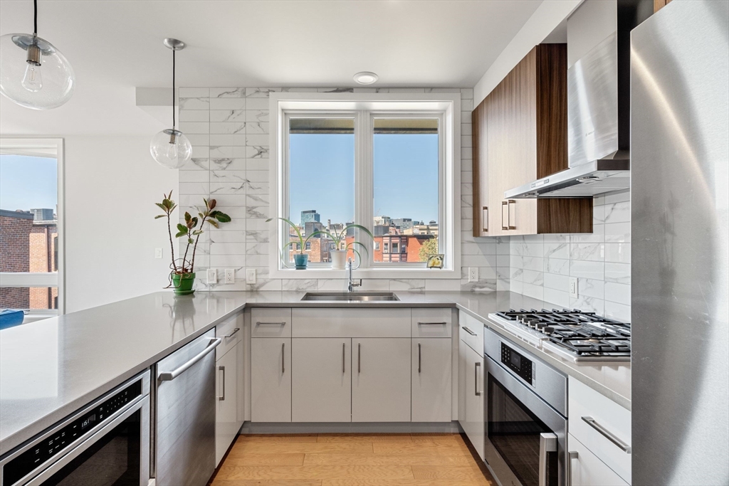 44-50 Symphony Road, Unit 403 Boston, MA 02115 - Photo 8 of 28 a kitchen with a sink stove and cabinets