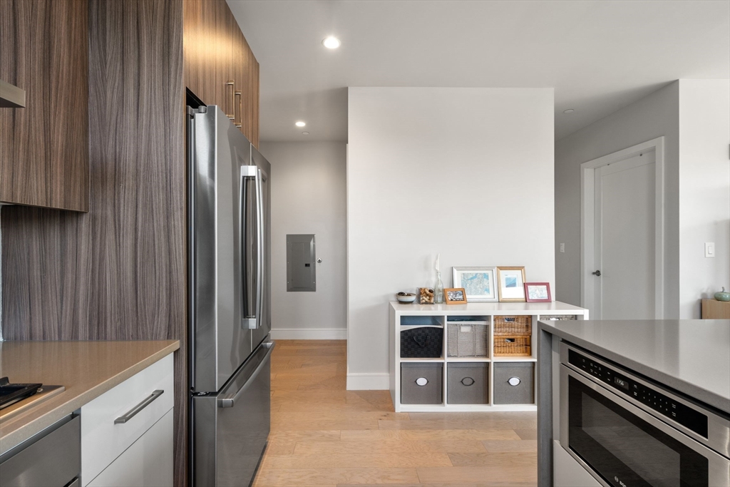 44-50 Symphony Road, Unit 403 Boston, MA 02115 - Photo 9 of 28 a room with stainless steel appliances kitchen island granite countertop a refrigerator and a stove top oven