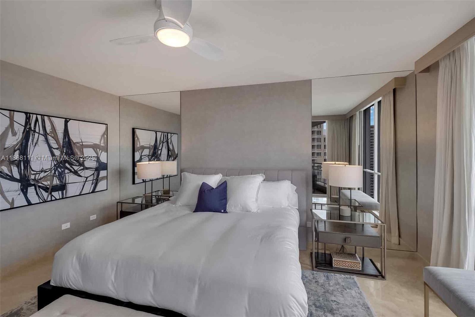 848 Brickell Key Drive, Unit 2605 Miami, FL 33131 - Photo 15 of 35 a bedroom with a bed window and walk in closet with wooden floor