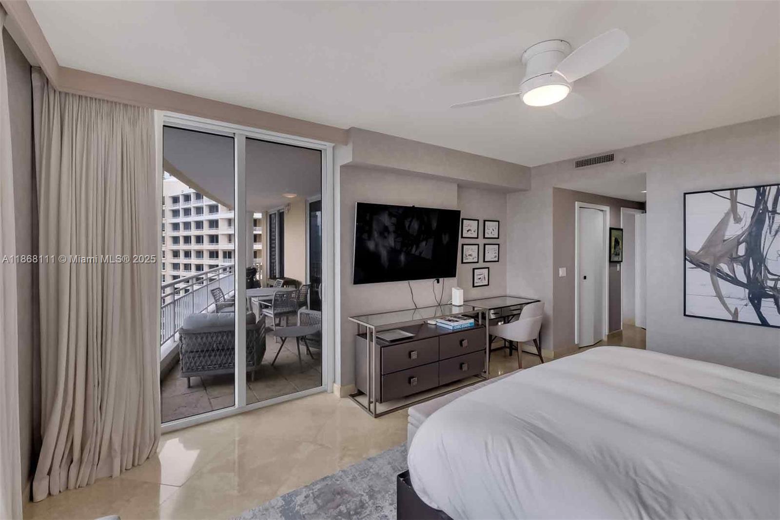 848 Brickell Key Drive, Unit 2605 Miami, FL 33131 - Photo 16 of 35 a bedroom with a bed and a flat screen tv