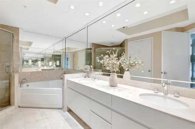 a bathroom with a tub sink and mirror