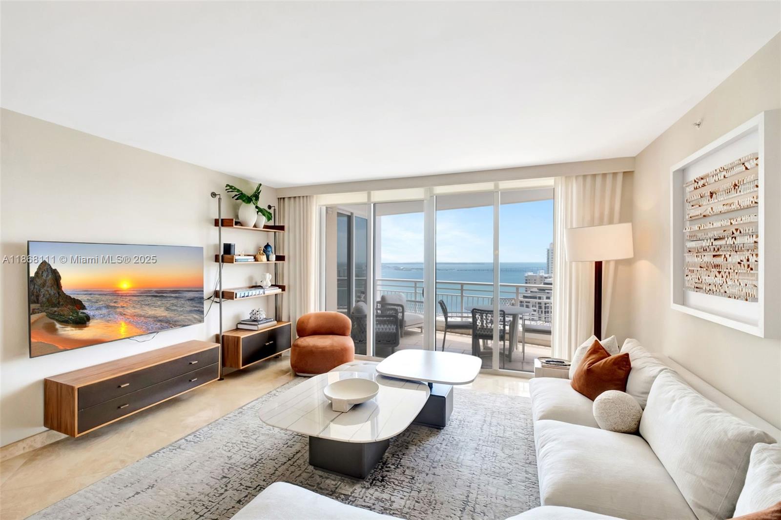 848 Brickell Key Drive, Unit 2605 Miami, FL 33131 - Photo 2 of 35 a living room with furniture and a flat screen tv