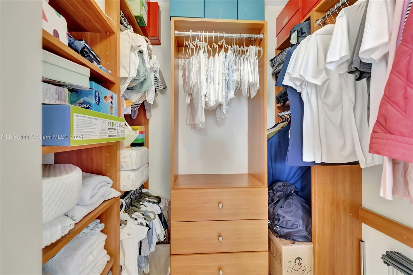 848 Brickell Key Drive, Unit 2605 Miami, FL 33131 - Photo 22 of 35 a view of walk in closet with clothes and shoes