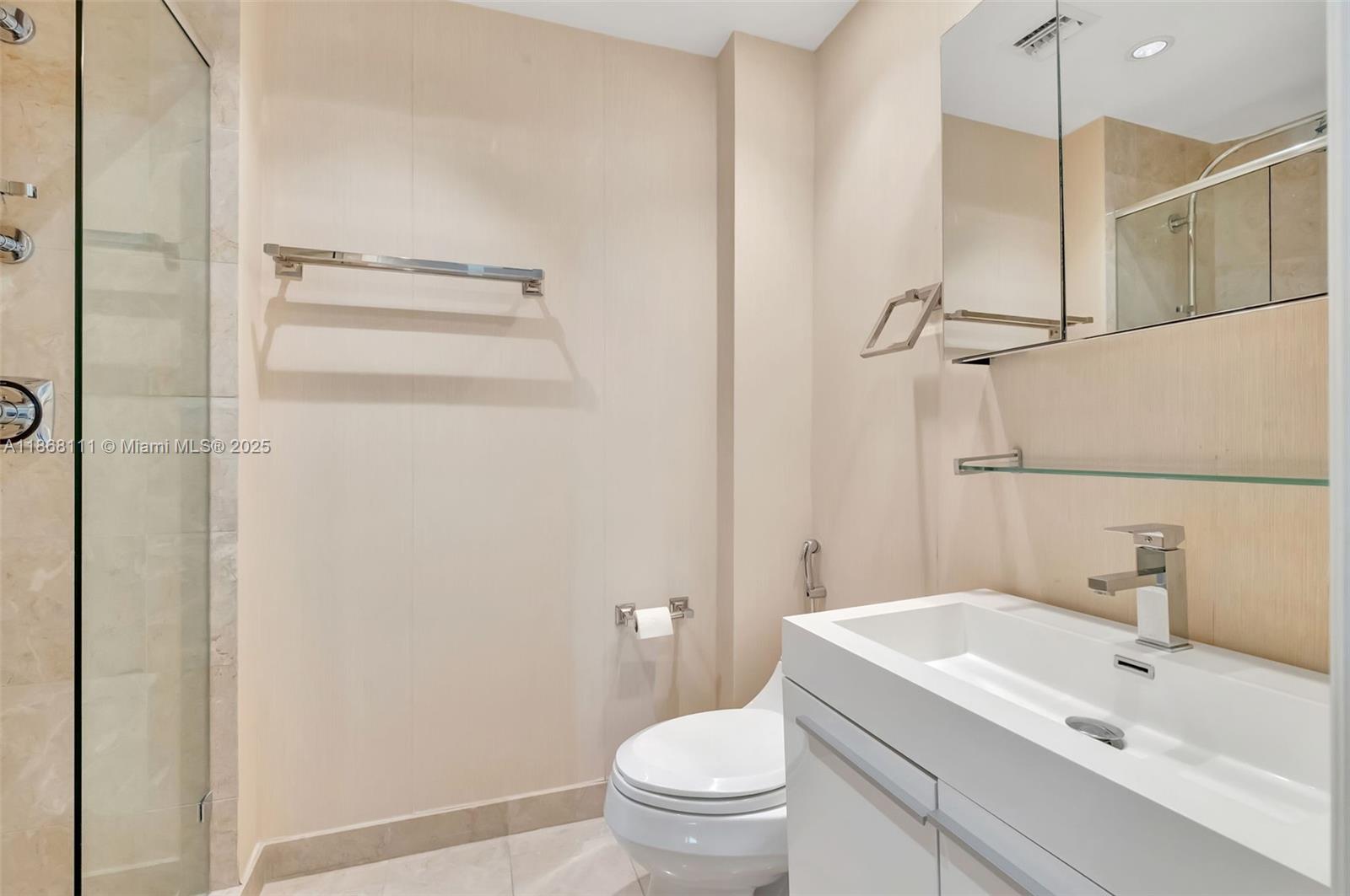 848 Brickell Key Drive, Unit 2605 Miami, FL 33131 - Photo 23 of 35 a bathroom with a sink a toilet and shower