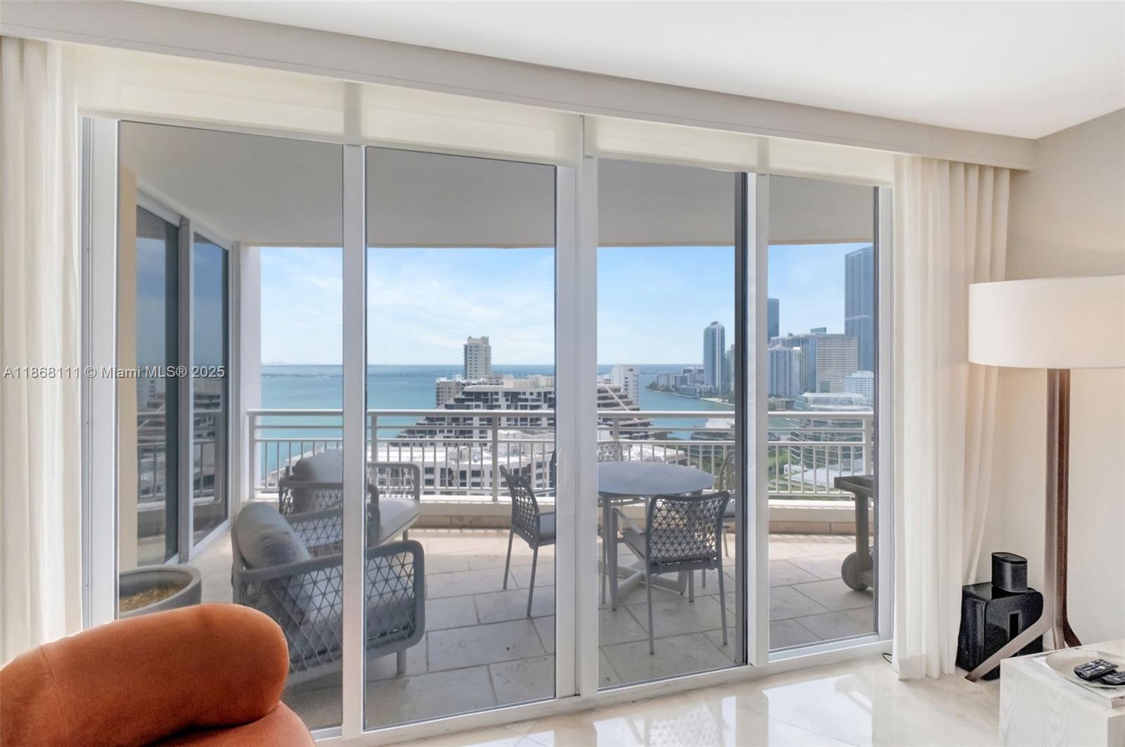 848 Brickell Key Drive, Unit 2605 Miami, FL 33131 - Photo 3 of 35 a room with furniture and a floor to ceiling window