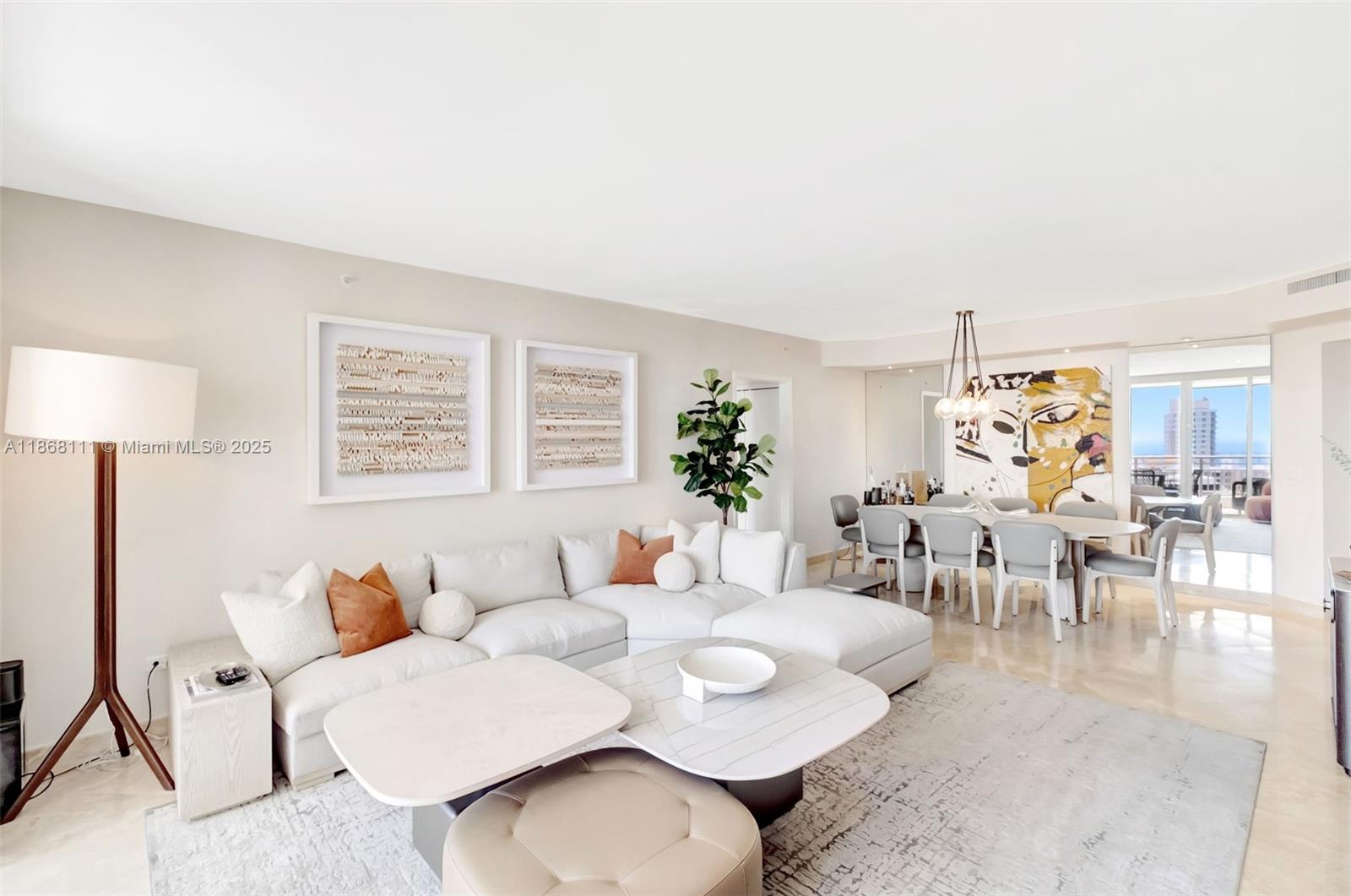 848 Brickell Key Drive, Unit 2605 Miami, FL 33131 - Photo 6 of 35 a living room with furniture and a table