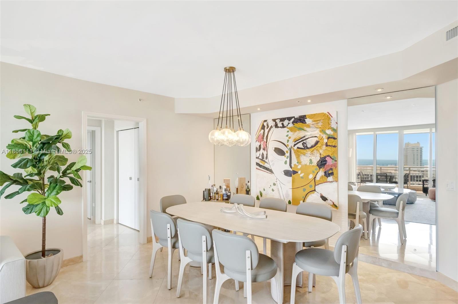 848 Brickell Key Drive, Unit 2605 Miami, FL 33131 - Photo 7 of 35 a view of a dining room with furniture window and wooden floor