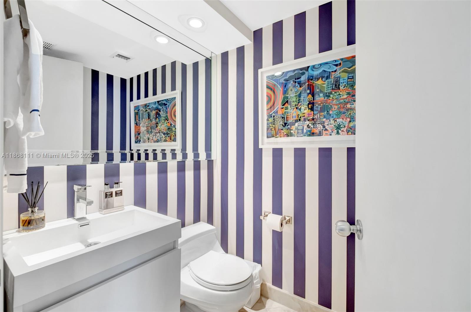 848 Brickell Key Drive, Unit 2605 Miami, FL 33131 - Photo 10 of 35 a bathroom with a sink a toilet and shower curtain