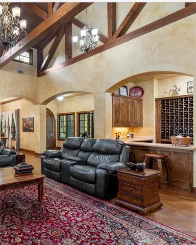 a living room with furniture and a chandelier
