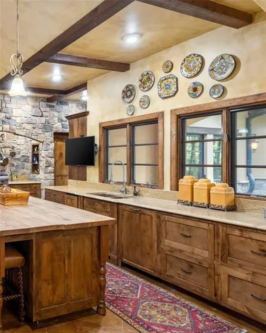 a kitchen with stainless steel appliances granite countertop a stove and large cabinets
