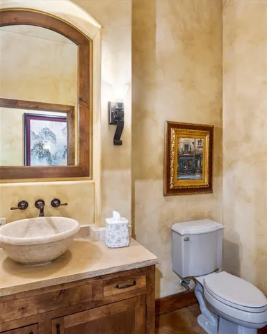 a bedroom with a bed and a lamp with the dresser