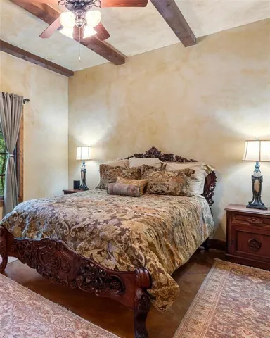 a bedroom with a bed dresser and a window