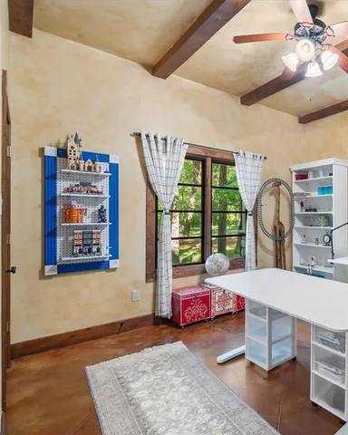 a living room with lots of furniture and a ceiling fan