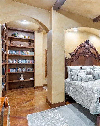 a living room with furniture and a book shelf