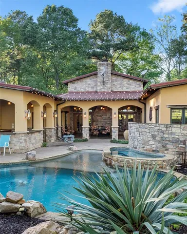 a view of a house with pool and sitting area