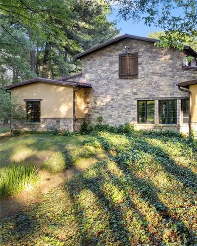 a brick house with a yard in front of it