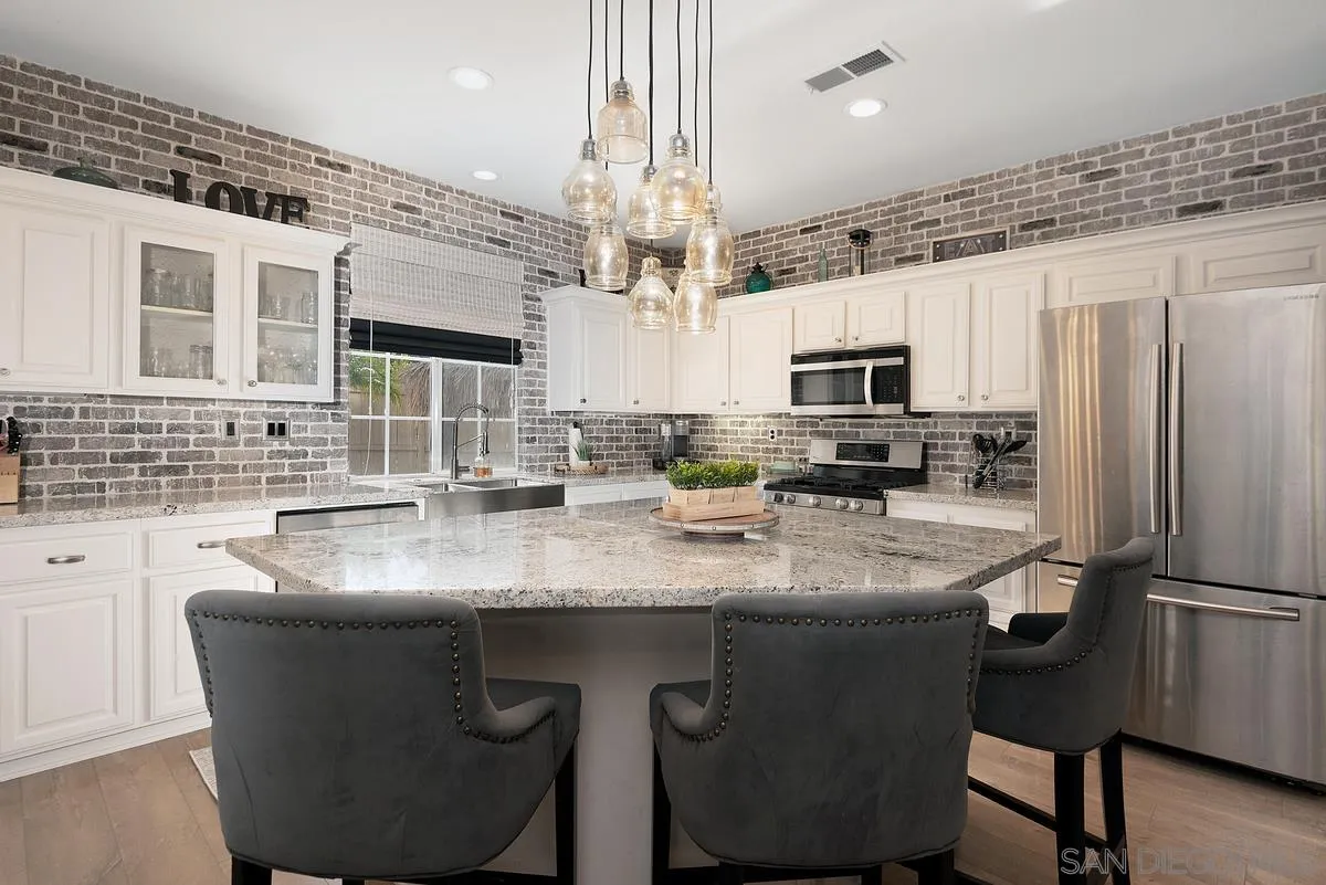 717 Via Cafetal San Marcos, CA 92069 - Photo 18 of 41 a kitchen with stainless steel appliances granite countertop a sink stove and refrigerator