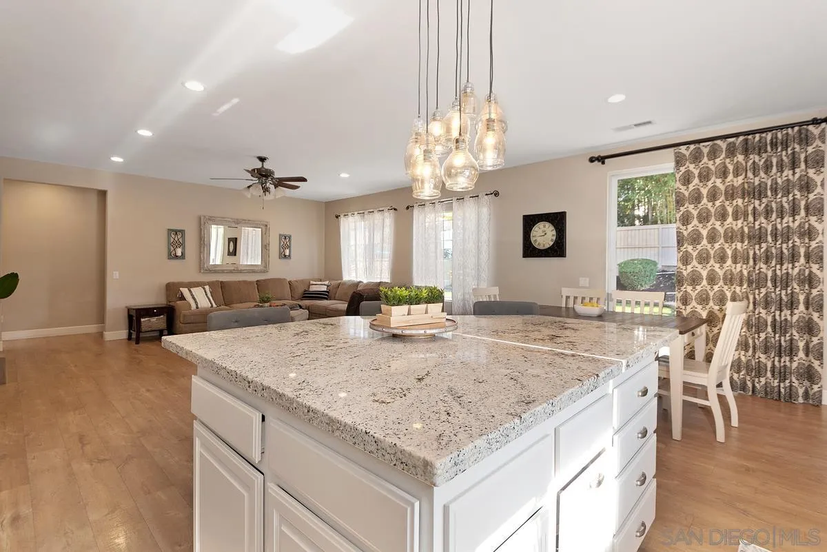 717 Via Cafetal San Marcos, CA 92069 - Photo 19 of 41 a bathroom with a granite countertop sink and a large mirror