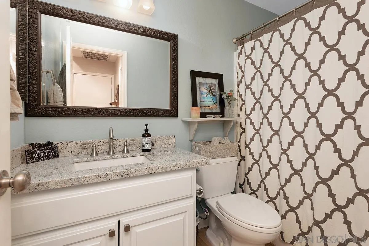 717 Via Cafetal San Marcos, CA 92069 - Photo 30 of 41 a bathroom with a granite countertop sink and a mirror