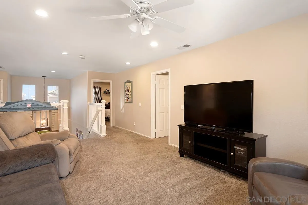 717 Via Cafetal San Marcos, CA 92069 - Photo 32 of 41 a living room with furniture and a flat screen tv