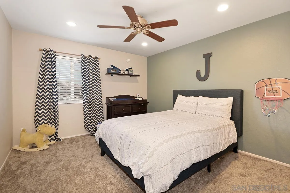 717 Via Cafetal San Marcos, CA 92069 - Photo 38 of 41 a bedroom with bed and a chandelier