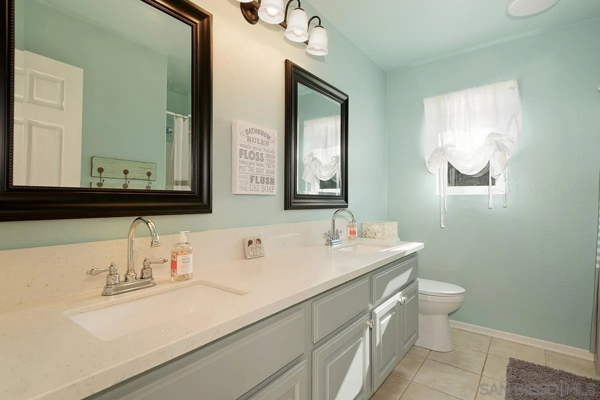 717 Via Cafetal San Marcos, CA 92069 - Photo 40 of 41 a bathroom with a sink and a mirror with toilet