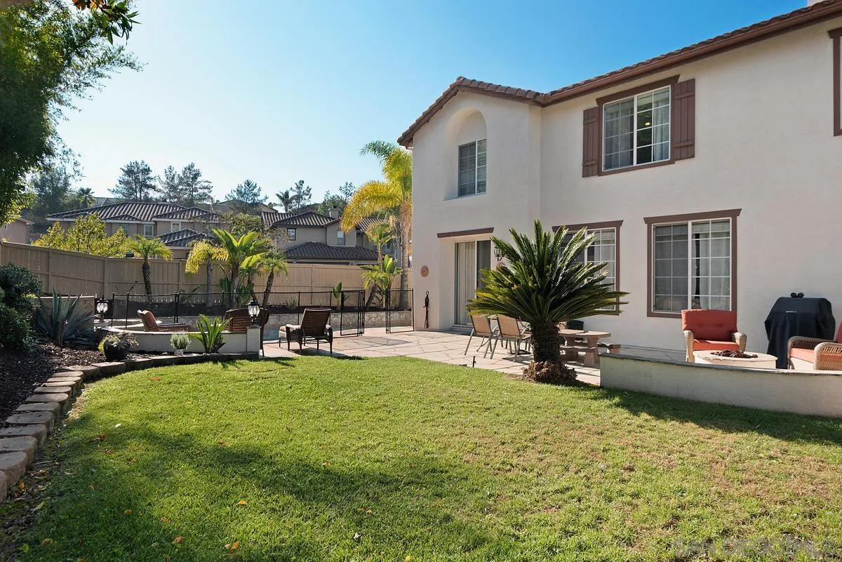 717 Via Cafetal San Marcos, CA 92069 - Photo 10 of 41 a view of a house with swimming pool and sitting area