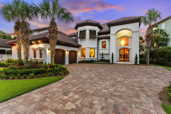 a front view of a house with a garden