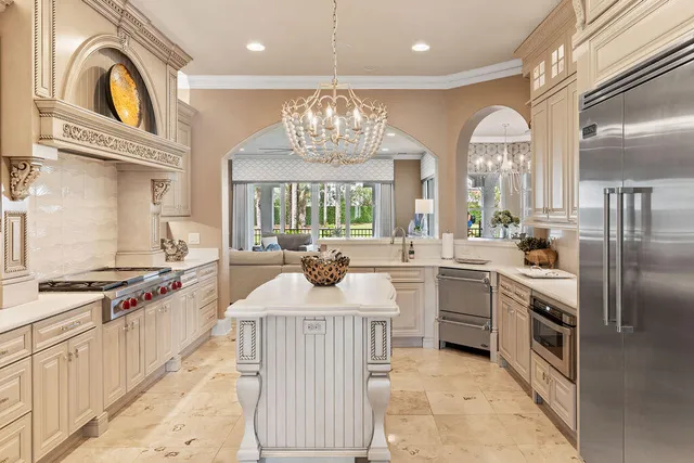 a view of a hallway with furniture and chandelier