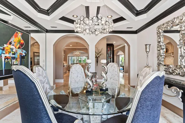 a bedroom with a large bed and a chandelier