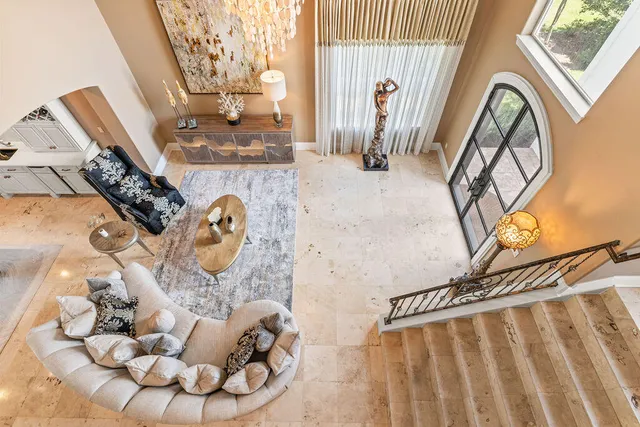 a view of hall way with furniture and floor to ceiling window