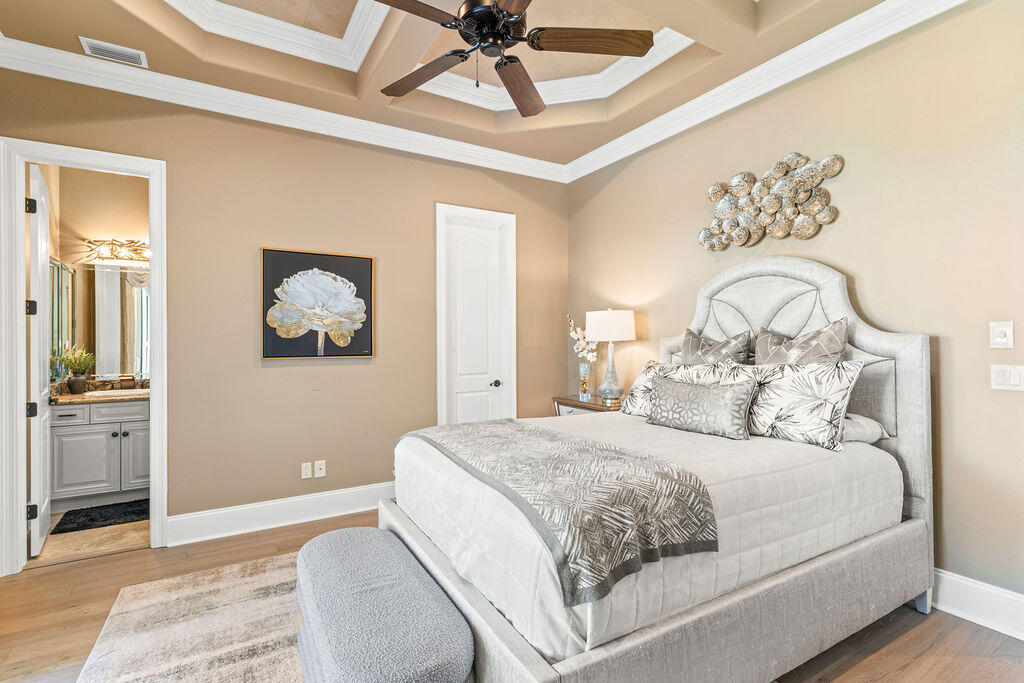 20 St Barts Bay Destin, FL 32541 - Photo 38 of 93 a bedroom with a large bed and a chandelier