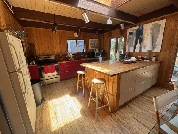 a kitchen with stainless steel appliances granite countertop a sink and wooden cabinets