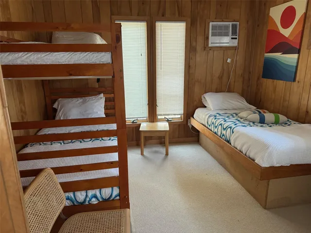 a bedroom with a bed a couch and dresser