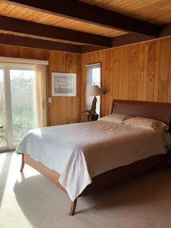 a bedroom with a bed and window