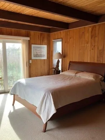 a bedroom with a bed and window