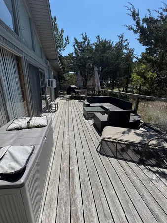 a view of balcony with wooden floor and outdoor seating