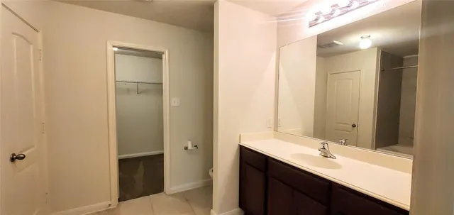 a bathroom with a double vanity sink mirror and shower