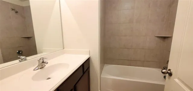 a bathroom with a bathtub and a sink