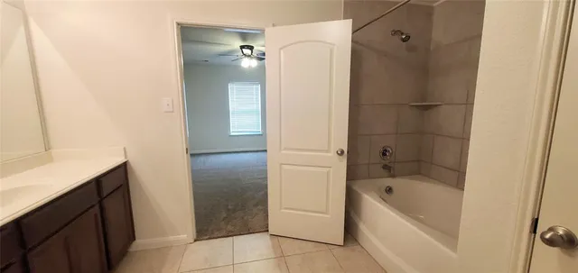 a bathroom with a bathtub and shower
