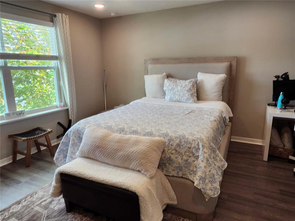 4718 Legendary Oak Street Tampa, FL 33610 - Photo 11 of 21 a bedroom with a bed a chair and a large window