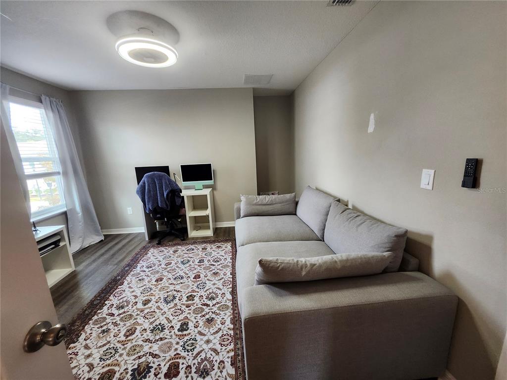 4718 Legendary Oak Street Tampa, FL 33610 - Photo 14 of 21 a living room with a couch and a flat screen tv