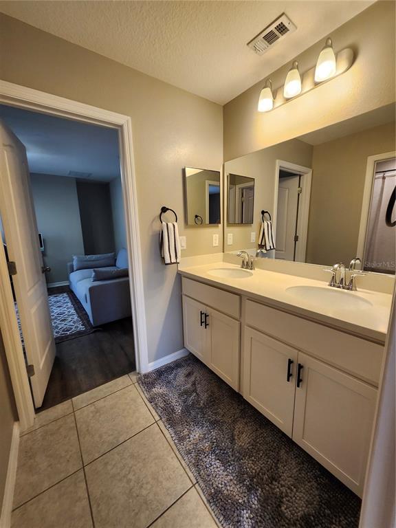 4718 Legendary Oak Street Tampa, FL 33610 - Photo 15 of 21 a bathroom with a double vanity sink and mirror