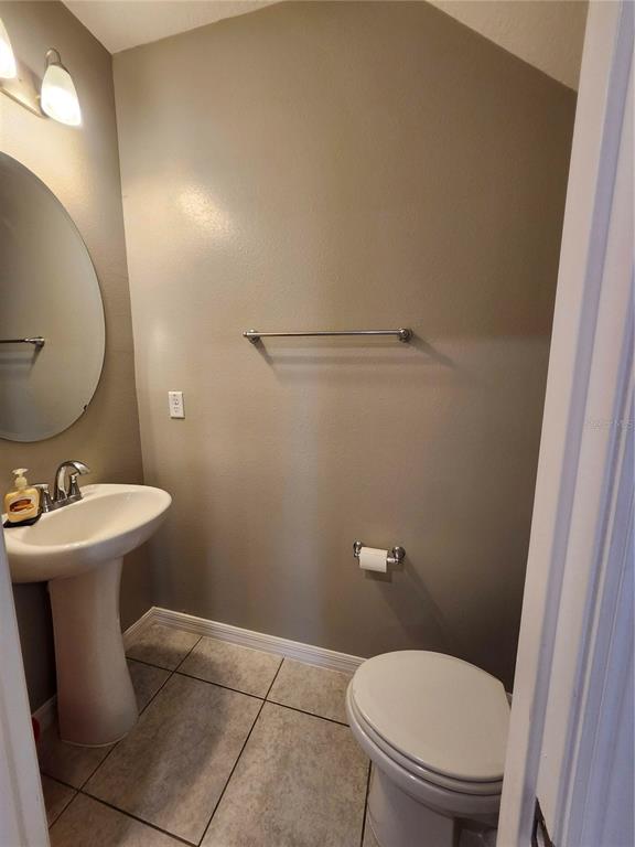 4718 Legendary Oak Street Tampa, FL 33610 - Photo 6 of 21 a bathroom with a sink toilet and a mirror
